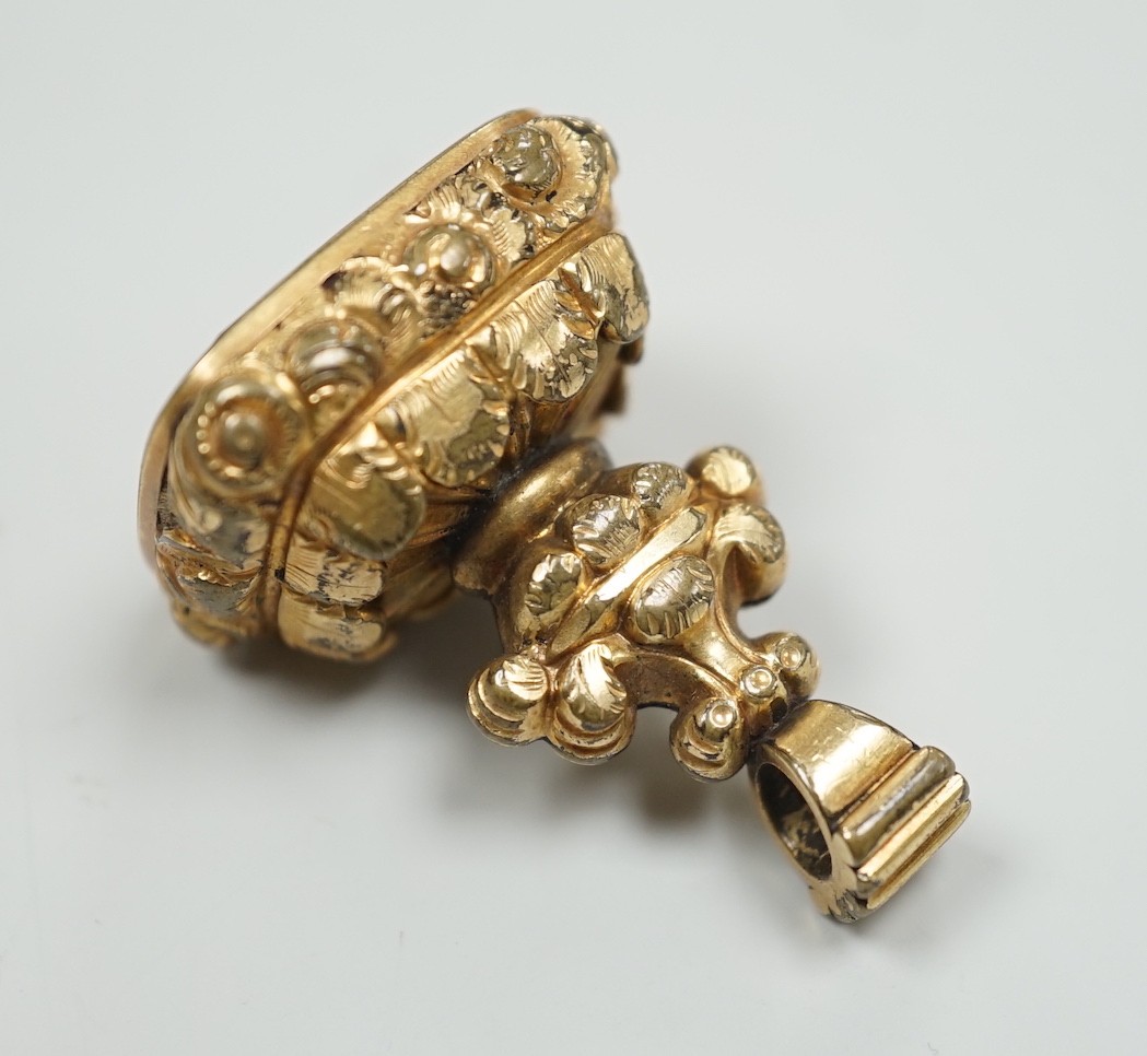 A Victorian yellow metal overlaid mounted citrine fob seal, the matrix carved with fox hunting scene, 34mm.